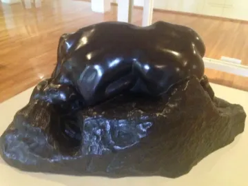 Rodin’s Danaid sculpture showing a bent female figure pressed over a rocky base