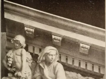 Marble relief from Apotheosis of Democracy showing a child holding grapes beside a reclining draped woman.