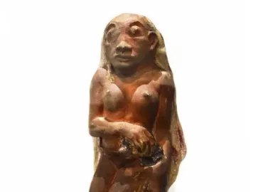 Oviri, a reddish-brown sculpture of a nude female figure standing over a wild animal