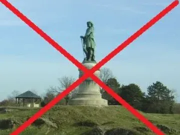 Vercingetorix Monument standing on a stone pedestal on a grassy hill with trees and a small gazebo in the background
