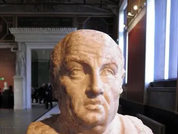 Double herm of Socrates and Seneca, showing the inscribed bust of Seneca in a museum gallery.