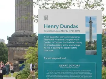 Information sign for Henry Dundas stands in front of the Melville Monument\'s stone base.