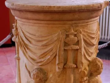The Four Seasons Altar, a cylindrical stone altar with relief carvings of draped fabric, vessels, and child-like figures.