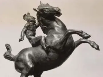 Rearing Horse and Mounted Warrior sculpture showing a bronze horse rearing with a small mounted figure clinging to its neck.
