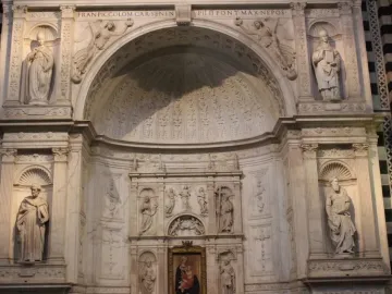White marble statue of Saint Gregory in a carved alcove, holding an open book and wearing a miter.