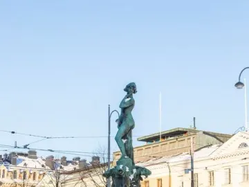 Havis Amanda fountain topped with a female figure and surrounded by marine sculptures, covered in snow.
