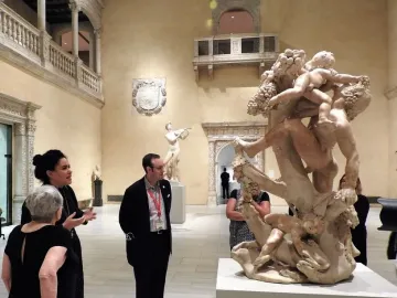 Marble sculpture A Faun Teased by Children showing a bearded faun surrounded by playful children figures.