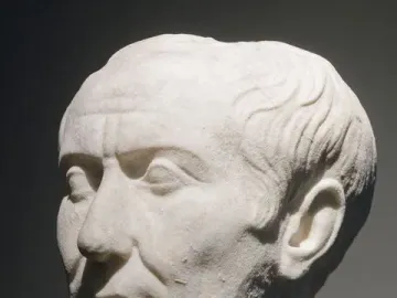 Tusculum portrait of Julius Caesar in weathered white marble, showing a stern face and receding wavy hair.
