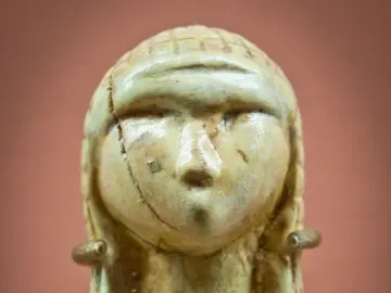 Venus of Brassempouy carved head with a textured cap and cracked surface