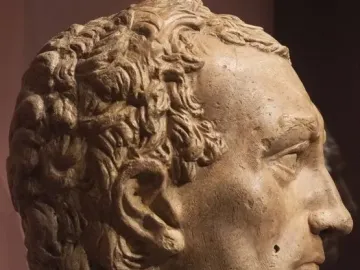 Side profile of the Gattamelata head sculpture in a light brown plaster-like material.