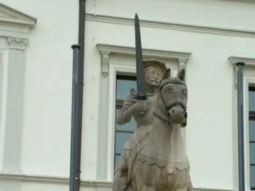 Haldensleben Roland statue of a crowned figure holding a sword while mounted on a horse.