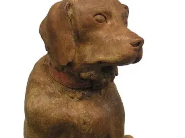 Cane Tago, a seated terracotta dog sculpture on a rectangular base, facing right.