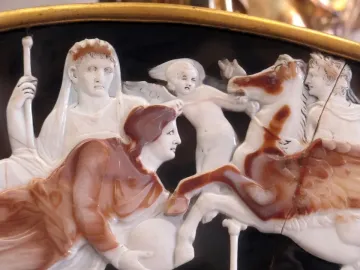 Great Cameo of France showing carved figures in layered relief, including a crowned woman, a winged child, a draped figure, and a rearing horse.