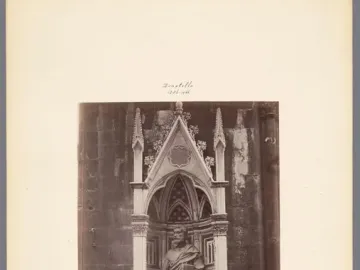 Saint Peter sculpture standing in a Gothic niche, holding a book.