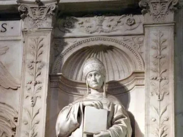 Saint Gregory marble statue in an ornate arched niche, holding a large book and wearing a papal tiara.
