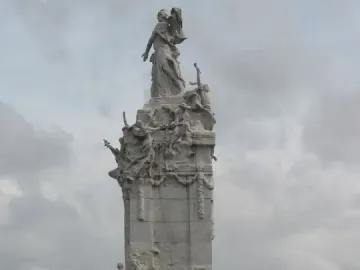 The Monument to the Carta Magna and the Four Regions of Argentina, a tall white stone sculpture with a standing female figure on top and detailed reliefs below.