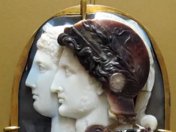 Gonzaga Cameo showing two carved profile portraits in a gold frame, with a helmeted figure in front and another profile behind.