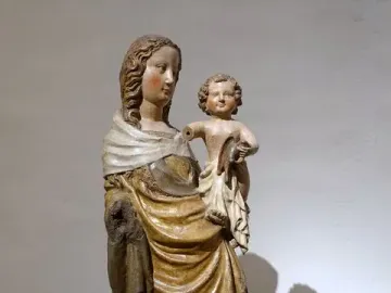 Friesentor Madonna, a painted wooden Madonna and Child sculpture with gilded drapery, the child resting on her hip with one arm missing.