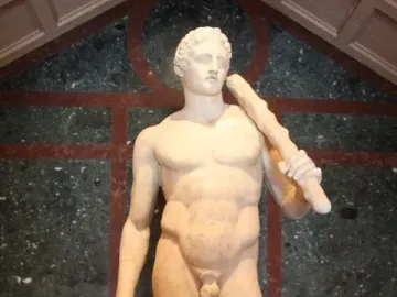 Lansdowne Heracles, a marble statue of a nude muscular man holding a club over his shoulder beside a lion skin.