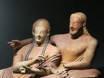 Sarcophagus of the Spouses showing two reclining terracotta figures, a woman and a bearded man, with archaic smiles.