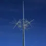 Ad Astra sculpture with a tall metallic pole and white starburst rods against a blue sky.