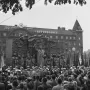 The Branting Monument shows a bronze figure addressing a crowd of workers with banners, with people gathered in front and the Aftonbladet building behind.