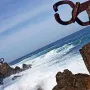 Peine del Viento rusted steel sculptures on coastal rocks with waves and the sea beyond