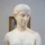 California, a white marble bust of a woman with short hair and bare shoulders on a pedestal