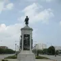 Victory Monument in Chicago, a tall multi-tiered monument topped by a soldier statue and set in a landscaped traffic circle.