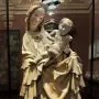 Krumlov Madonna sculpture of a woman cradling a child, with flowing carved drapery