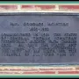 Bronze commemorative plaque for Stonewall Jackson mounted on a red brick wall.