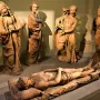Compianto sul Cristo morto terracotta sculpture showing the dead Christ surrounded by grieving figures with expressive gestures and open mouths.
