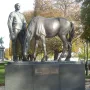 Monument to the Russian Expeditionary Force showing a uniformed man beside a horse with its head lowered, on a stone pedestal with Cyrillic and French inscriptions.