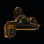 Thutmose III sphinx figurine in profile with gold inlays on a dark background