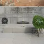 Unknown Soldier Monument with a granite memorial wall, Cyrillic inscriptions, and an eternal flame in a circular basin.