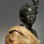 Bust of Woman from the French Colonies showing a dark-skinned female figure with curled hair, a small headpiece, and draped fabric.