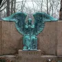 Haserot Angel bronze sculpture with outstretched wings and inverted torch atop a granite monument