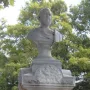 Beriah Magoffin Monument showing a stone bust of a bearded man on an ornate pedestal with a circular relief carving.
