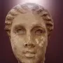 Marble head of Lycosoura Artemis with wavy braided hair swept back