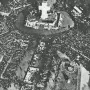 A large crowd gathers around the Monument to the Carta Magna and Four Regions of Argentina, with a tall cross rising from the top of the monument.