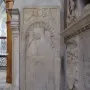 Tomb of Giovanni Crivelli stone relief with a carved effigy beneath a scalloped arch and winged figures above.