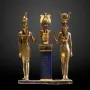 Osorkon II Triad showing three golden figures on a blue hieroglyphic pillar.