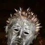 Close-up of the Knife Angel sculpture’s metallic head with hollow eyes and blade-like spikes forming the hair.
