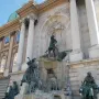 Fountain of King Matthias with sculptural figures set before a grand classical facade in Budapest.