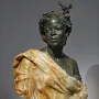 Bust of Woman from the French Colonies showing a dark-skinned female figure with curled hair, a small headpiece, and draped fabric.