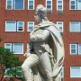 George Washington marble statue in military attire standing on a pedestal