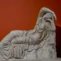 Sleeping Ariadne, a white marble sculpture of a reclining woman with her head resting on her arm.
