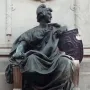 Bronze seated female figure on the Monument to Giuseppe Garibaldi, holding a broken chain and a decorated shield.