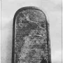Mesha Stele, a tall inscribed stone stele with a rounded top and a damaged middle section.