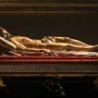 Cristo Yacente, a recumbent sculpture of Christ lying on a raised platform with visible wounds.